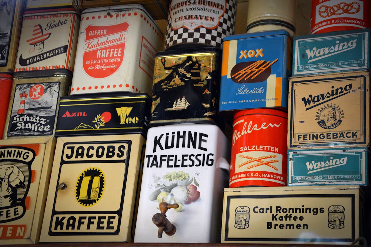 discover Diverse vintage German coffee tins and other containers displayed on a shelf showcasing nostalgic packaging.
